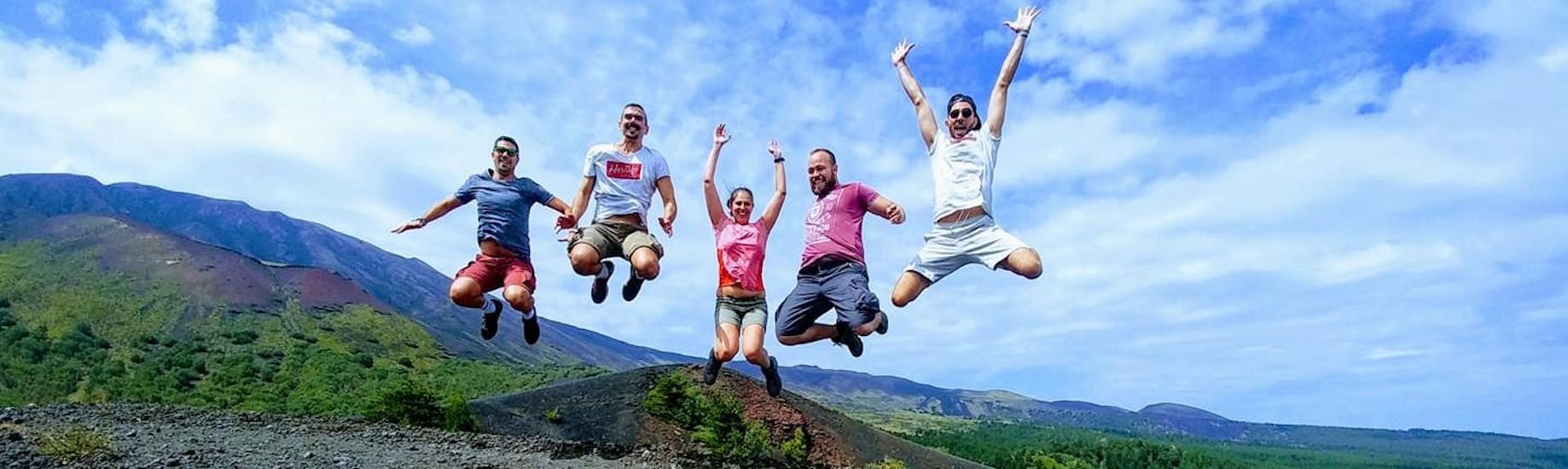 A group of people jumping on Etna with Sicily Adventure Taormina.