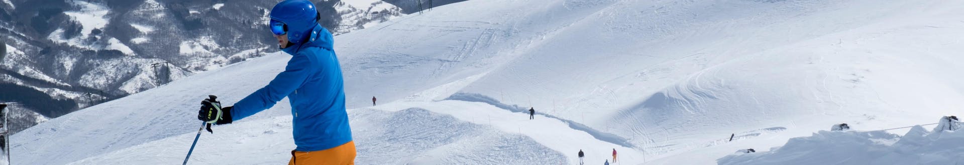 A skier goes down the slopes of the Abetone ski resort in Val di Luce where ski school teach ski lessons.