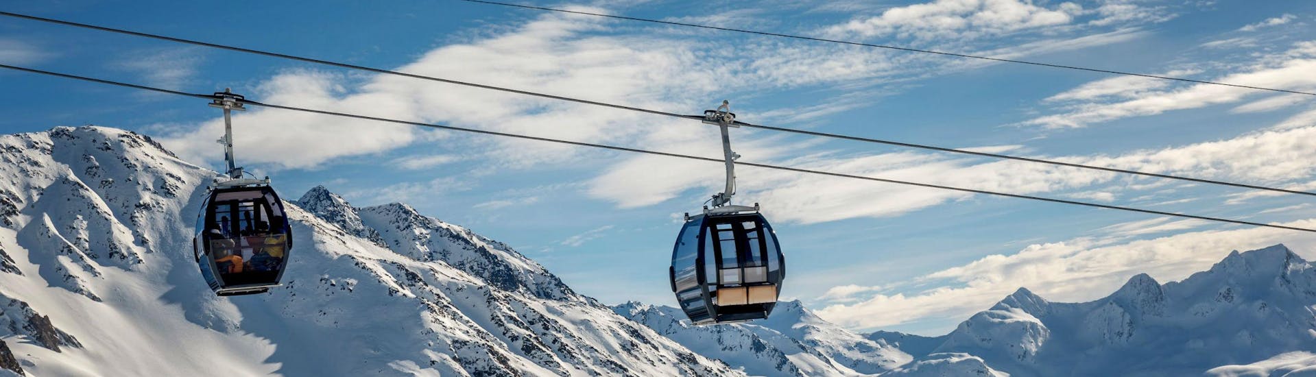 A view of the cable car carrying skiers up to the top of the mountain in the ski resort of Andermatt-Sedrun-Disentis, where local ski schools offer a selection of ski lessons.