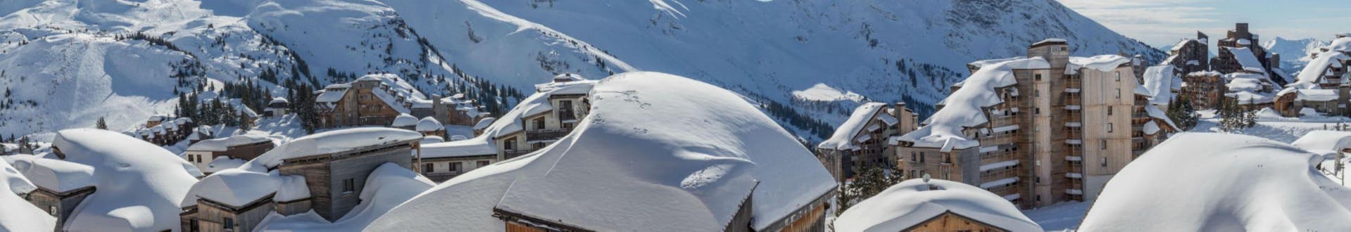 A panoramic view of the snow-covered mountain huts and hotels in the French ski resort of Avoriaz, where local ski schools offer a wide selection of ski lessons. 