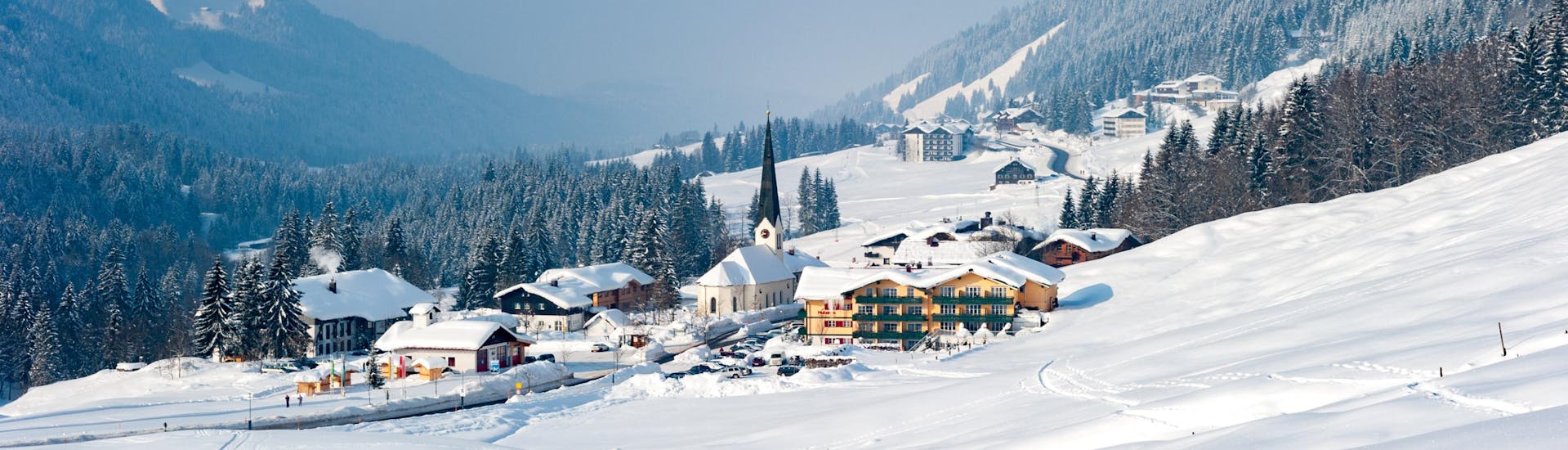 An image of the dreamy little Bavarian village of Baldersachwang in winter, a popular ski resort in which visitors can book ski lessons with one of the local ski schools.