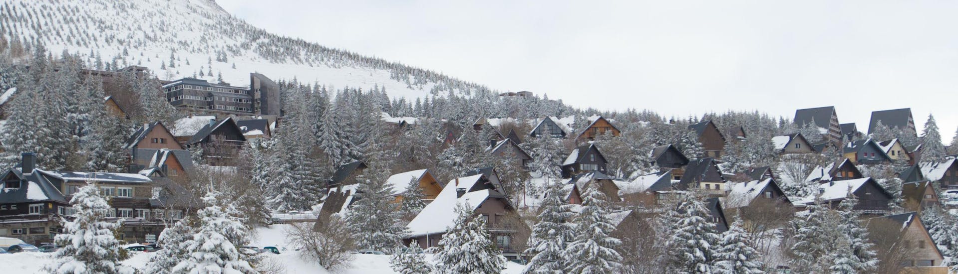 A view of the picturesque village of Besse - Super Besse, a French ski resort where visitors can book ski lessons with the local ski schools.
