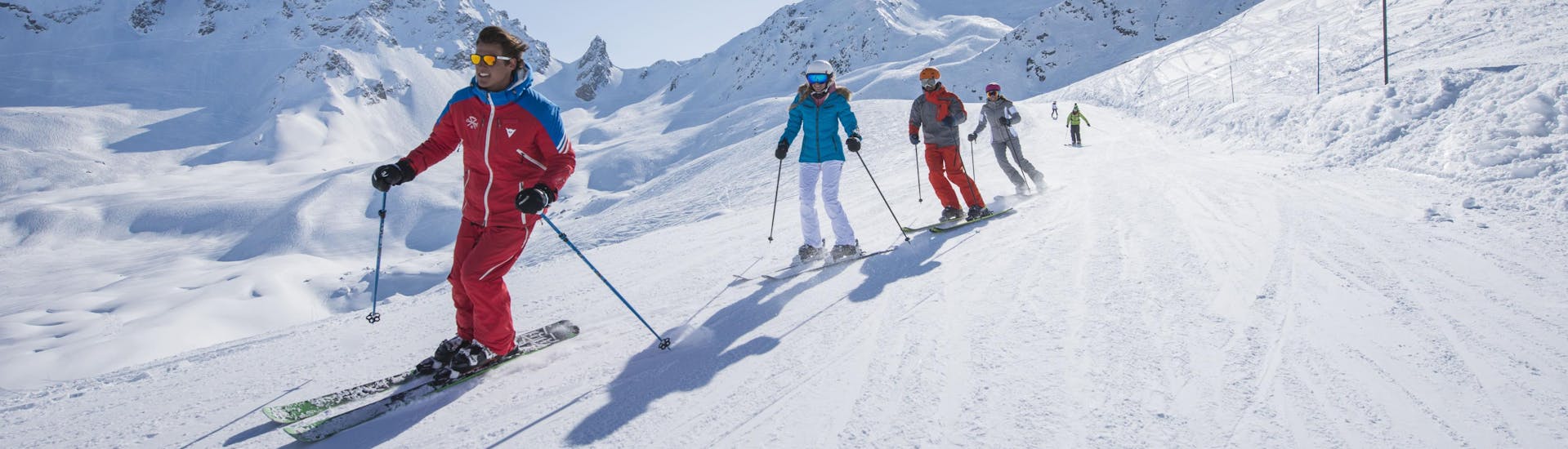 A group of skiers enjoy a day out in the slopes of the Courchevel 1550 ski resort where ski schools offers their ski lessons.