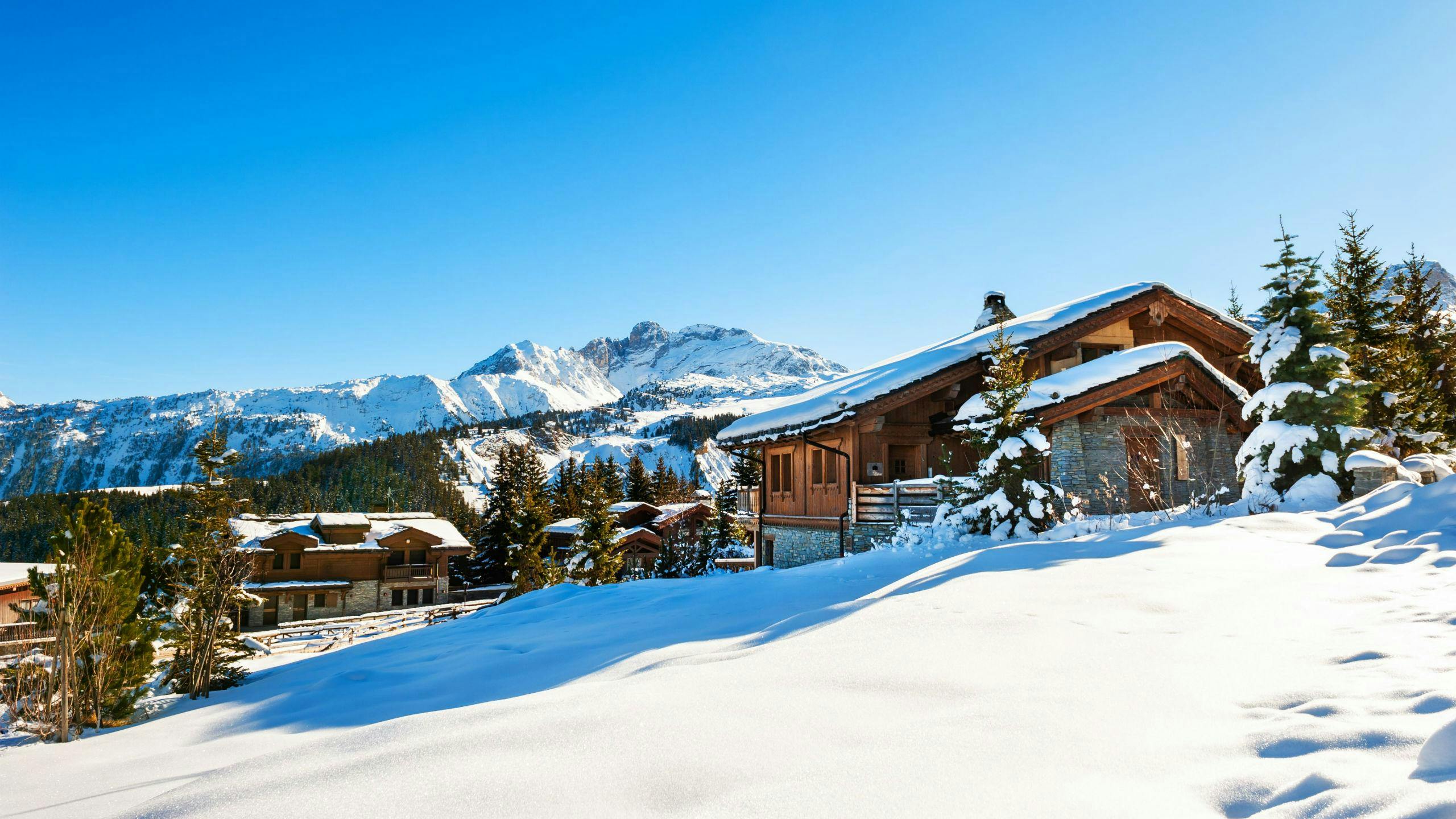 ski-school-courchevel_SEM-Resort-Hero An image of a couple of snow-covered mountain huts in the popular French ski resort of Courchevel, where visitors can learn to ski in one of the many ski lessons organised by the local ski schools.