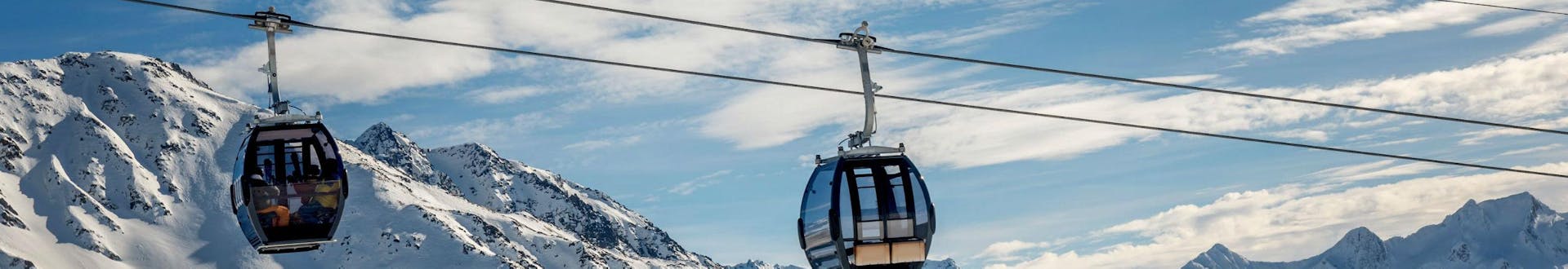 A view of the cable car carrying skiers up to the top of the mountain in the ski resort of Disentis, where local ski schools offer a selection of ski lessons.