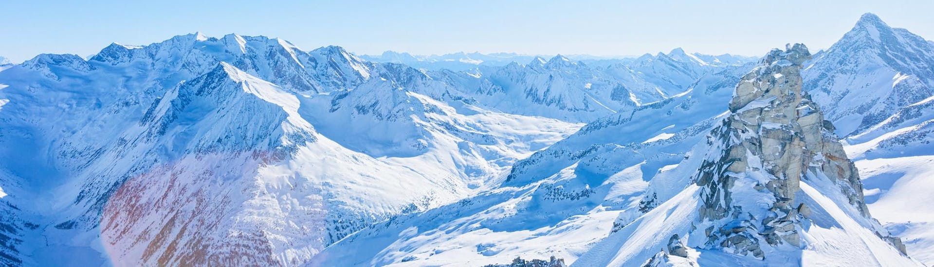 View of the snow-covered peaks of Hintertux Glacier, where local ski schools offer their ski lessons.