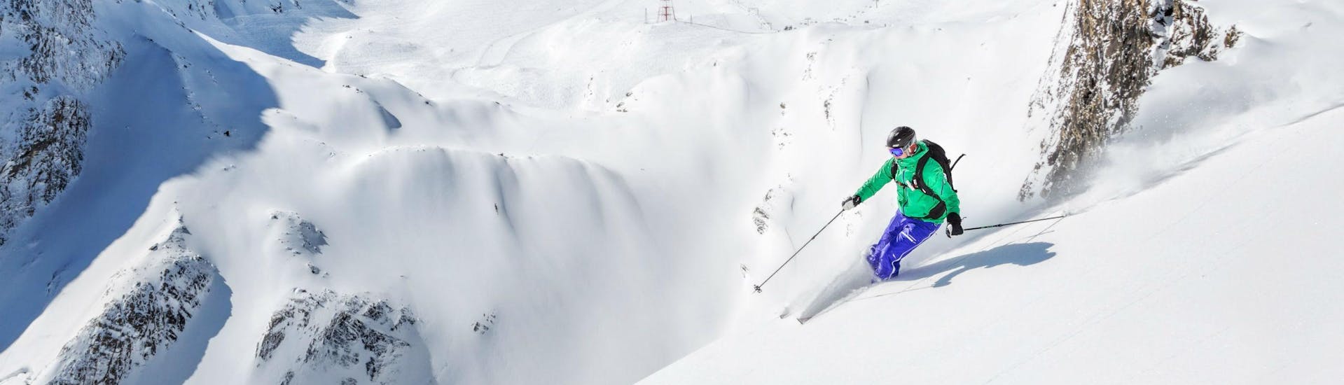 A skier is riding through some fresh powder snow in the Austrian ski resort of Kaprun, where beginners as well as advanced skiers can book ski lessons with the local ski schools.