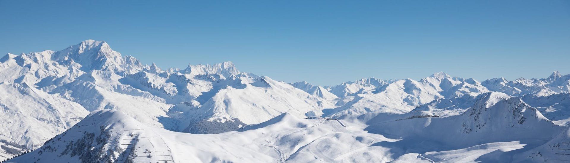 View of the snow capped mountains of La Plagne ski resorts where ski school provide ski lessons.