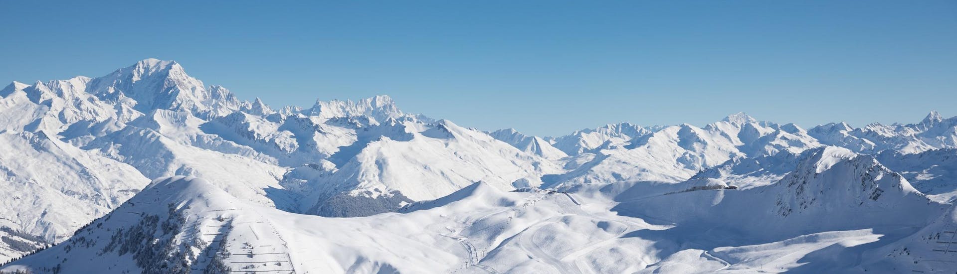 View of the snow capped mountains of La Plagne ski resorts where ski school provide ski lessons.