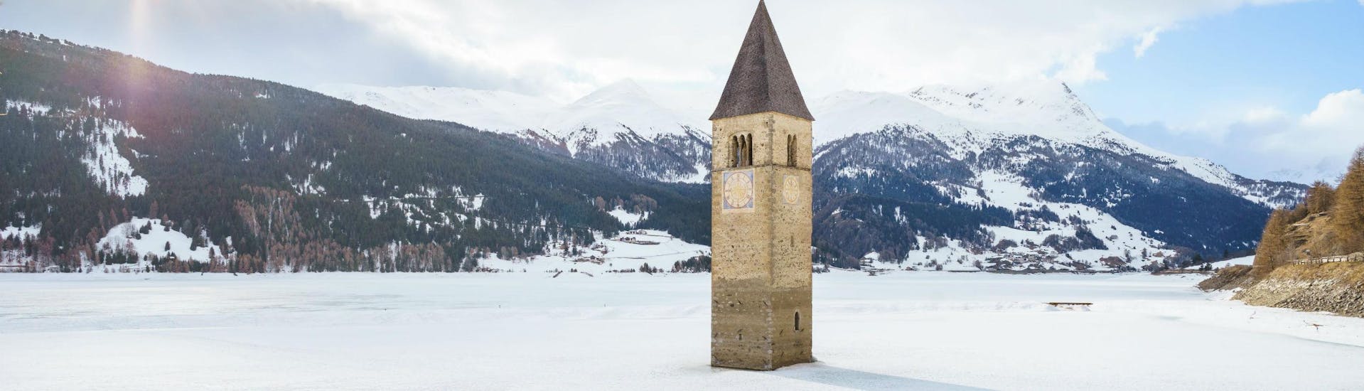 An image the sunken church in Lake Reschen close to the Austrian ski resort of Nauders, where aspiring skiers can book ski lessons with one of the local ski schools.