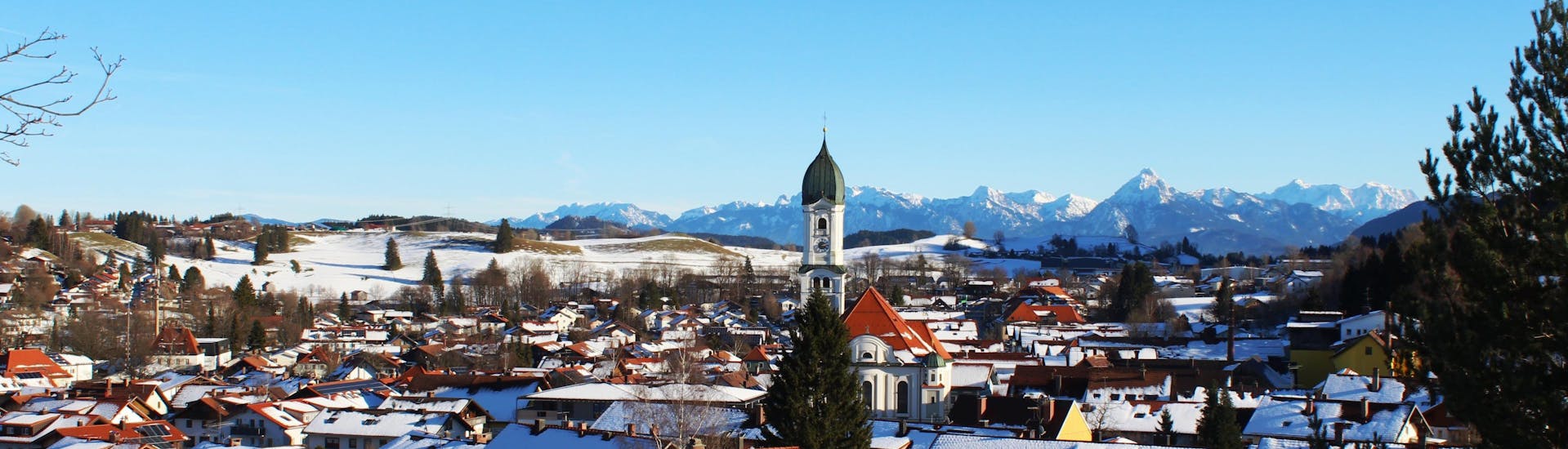 Town of Nesselwang covered in snow near the slopes.