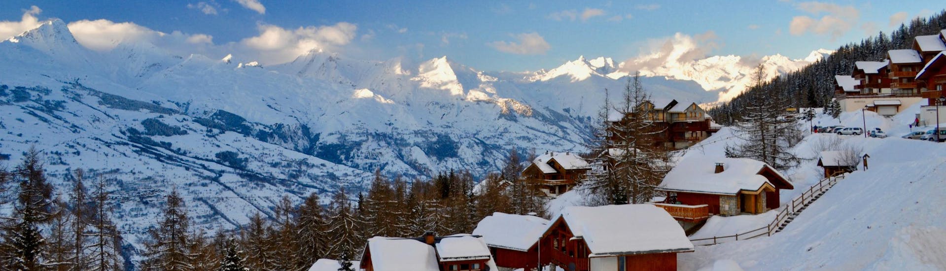 A view across the snow-covered valley of Peisey Vallandry, a beautiful French ski resort where first-time skiers can enjoy a selection of ski lessons.