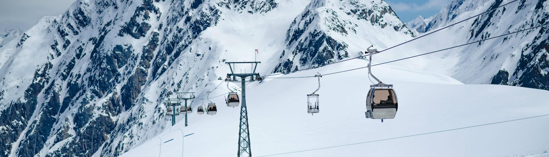 An image of a gondola carrying skiers to the top of the Stubai Glacier, where local ski schools carry out their ski lessons.