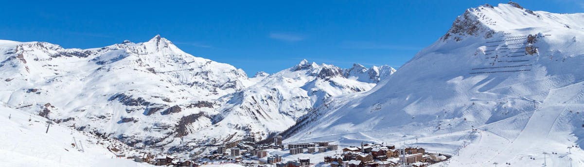 ski-school-tignes_SEM-Resort-Hero A view of the French ski resort of Tignes under the clear blue sky with its many pistes used by the local ski schools to carry out their ski lessons.