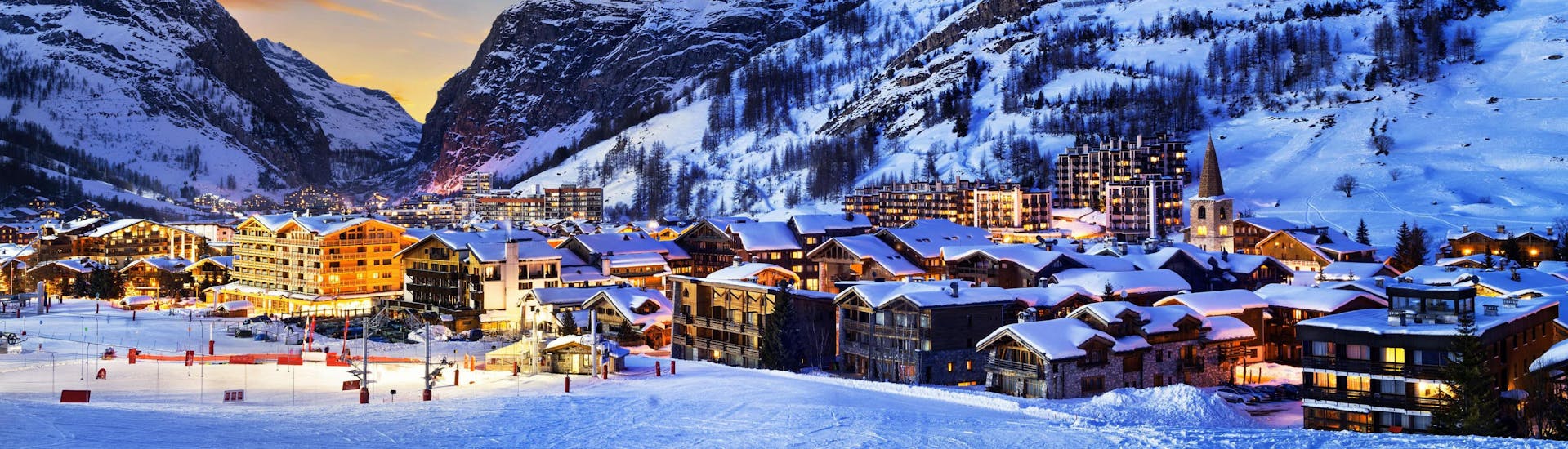 A view of the wonderful French ski resort Val d'Isère surrounded by snow at sunset.