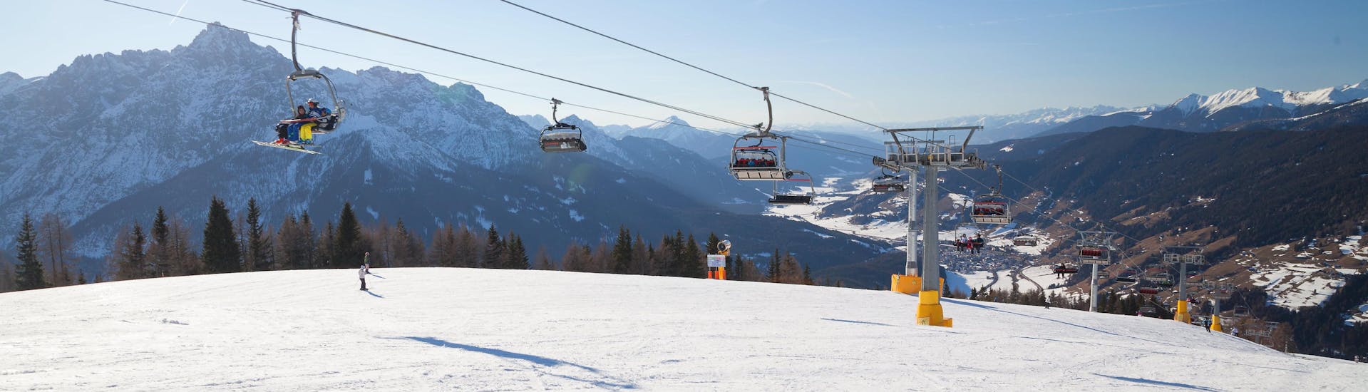 Skiers on the slopes and in the ski lift in Versciaco - Monte Elmo in Italy.