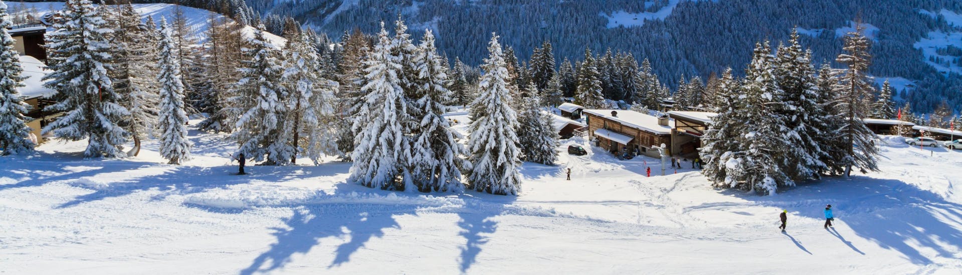 A panoramic view of the ski slopes and the surrounding mountains of Villars, a popular Swiss ski resort  in the canton of Vaud where visitors can book ski lessons with one of the local ski schools.