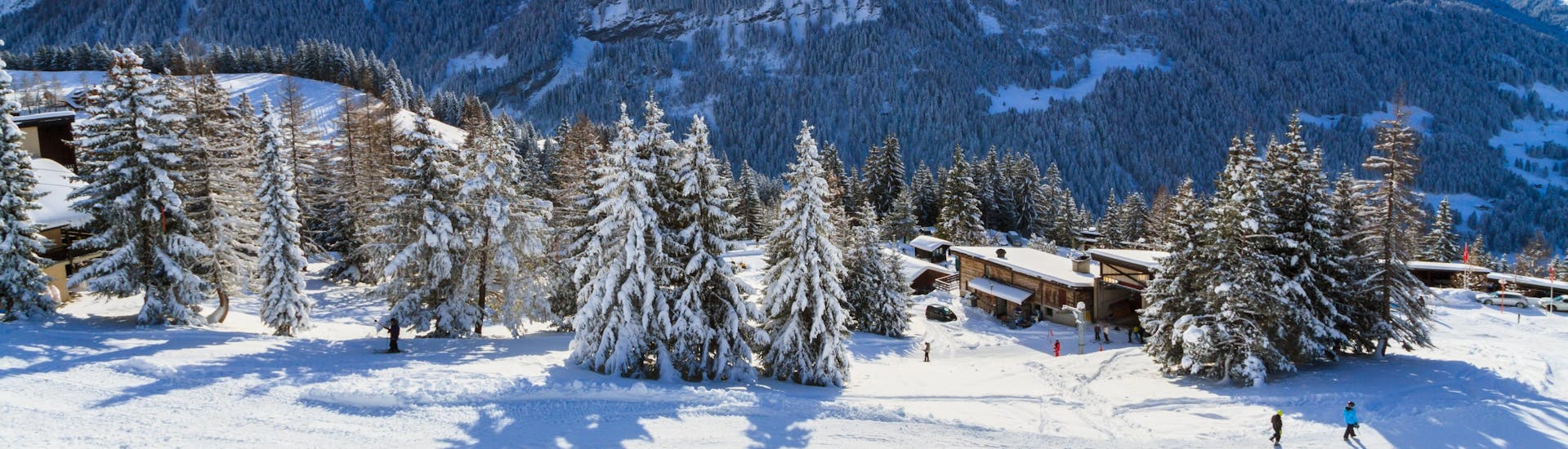 A panoramic view of the ski slopes and the surrounding mountains of Villars, a popular Swiss ski resort  in the Alpes Vaudoises where visitors can book ski lessons with one of the local ski schools.