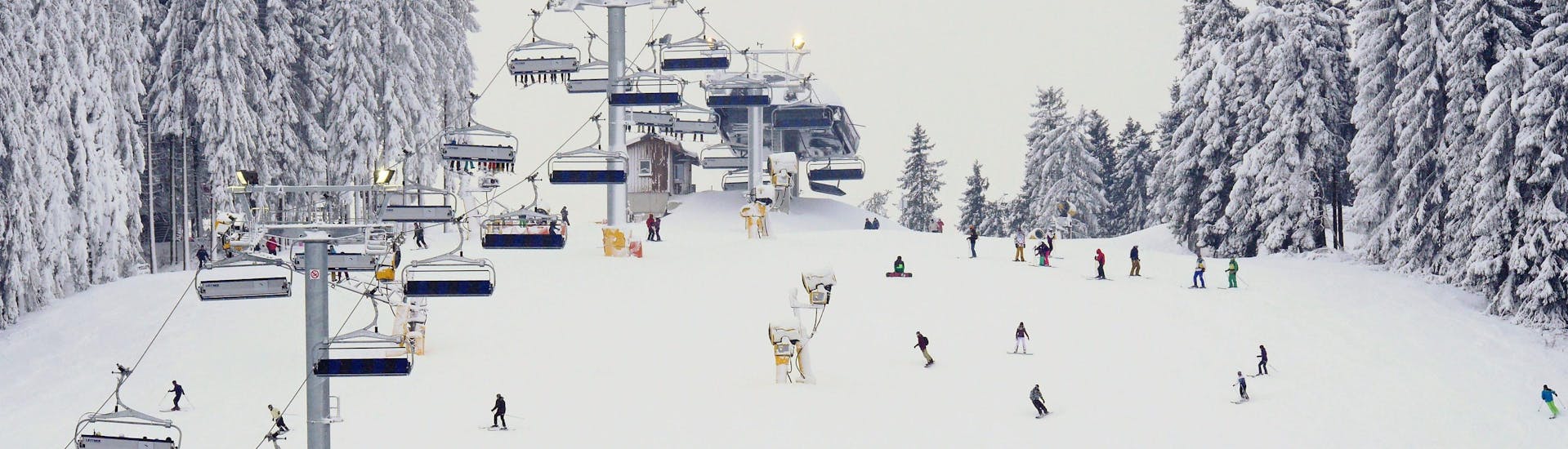 A view of a snowy mountain top in the ski resort of Winterberg (Schlossberg), where ski schools gather to start their ski lessons.
