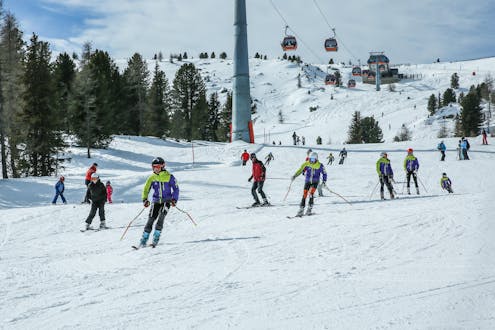 Adults and kids skiing in Kreishberg ski resort.