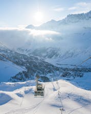 An image of the gondola carrying skiers up to the top of the mountain in Breuil-Cervinia, a popular ski resort for booking ski lessons with one of the local ski schools.