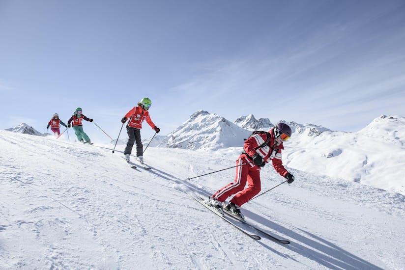 A group of kids is exploring the slopes of the vast Silvretta Montafon ski resort during their ski lessons with Skischule Schruns.