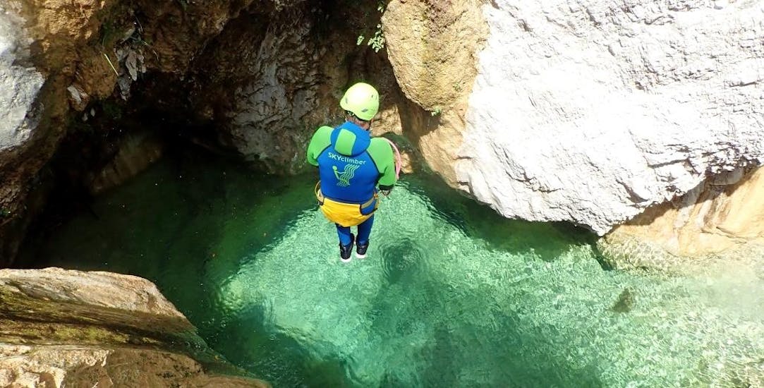 Uomo che salta in una piscina naturale durante il canyoning con SKYclimber Tremosine.