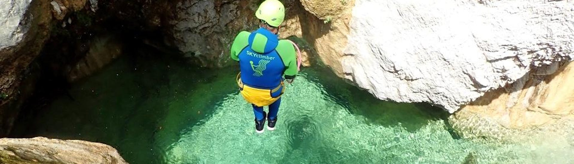 Man jumping into a natural pool during canyoning with Skyclimber Tremosine