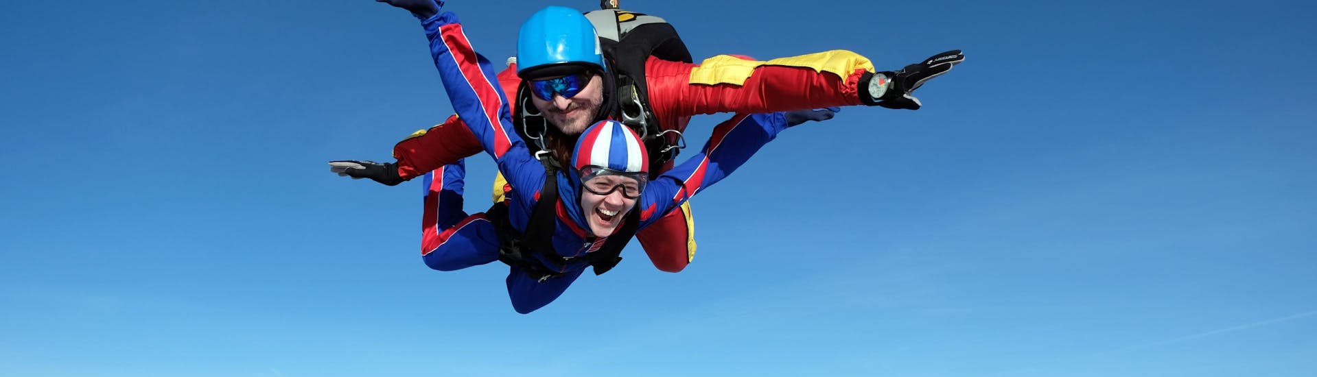 Woman full of excitement while tandem skydiving