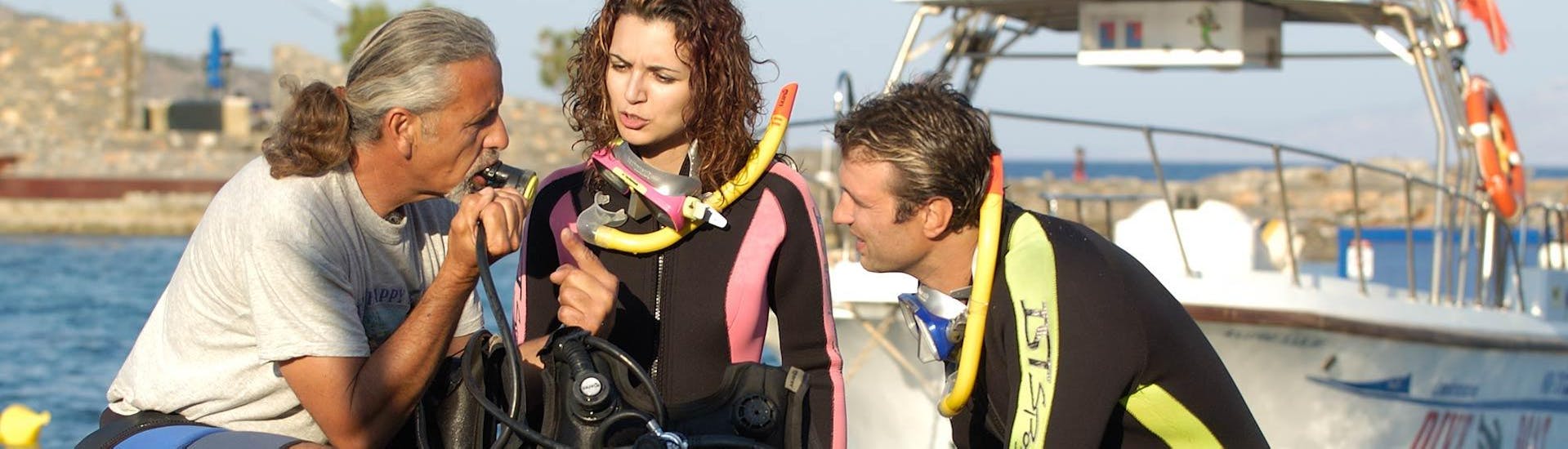 Two divers learning a lot with their instructor during their PADI course with Creta's Happy Divers.