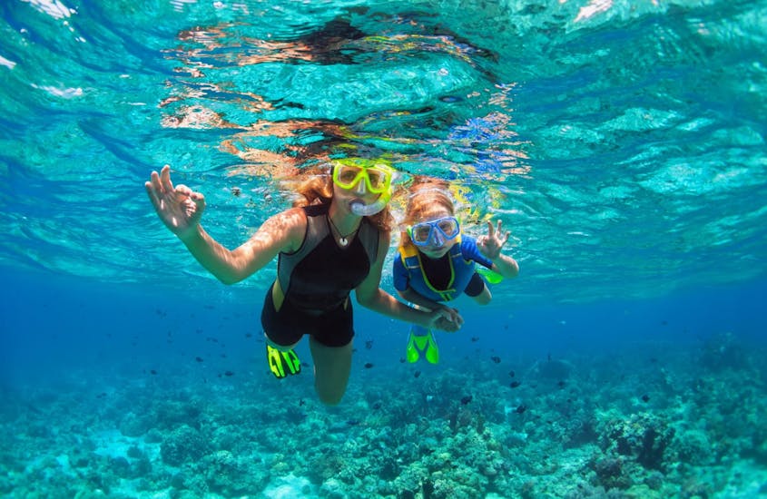 Mother and daughter snorkeling together and having fun underwater