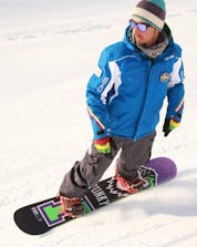 A boy descends the slopes of Livigno with a snowboard
