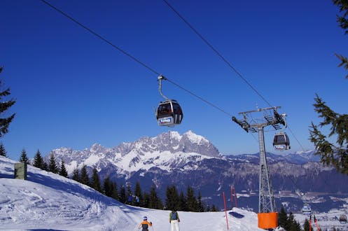 Erwachsene und Kinder beim Skifahren im Skigebiet St Johann in Tirol.