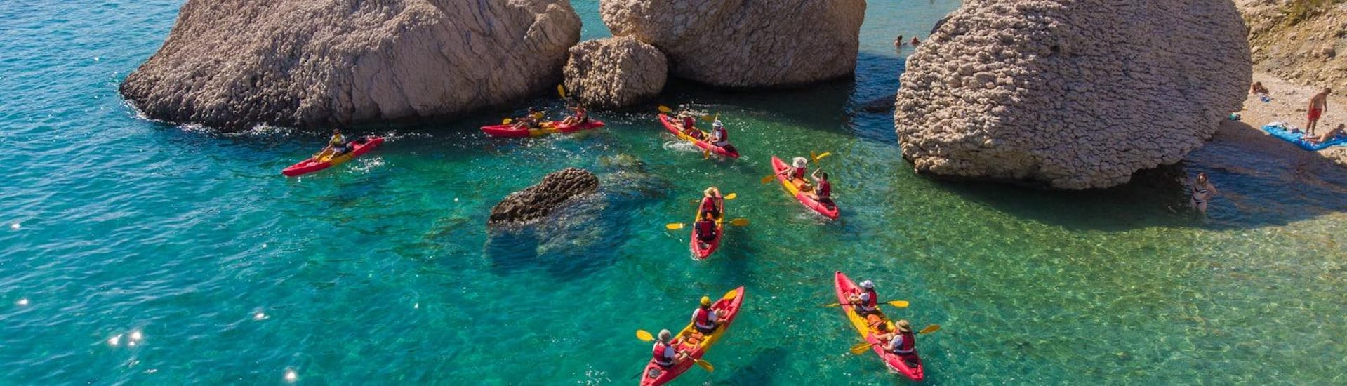 A picture from above off all kayaks on the clear blue water during a tour offered by Sunturist.