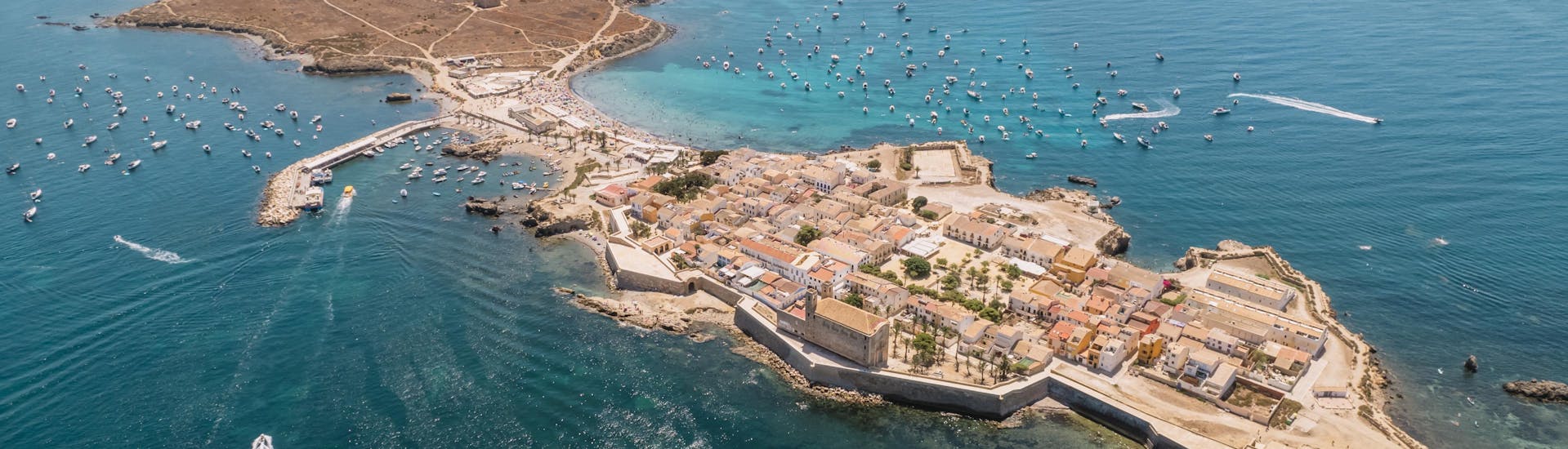 Aerial view of boats reaching the island of Tabarca in Alicante.