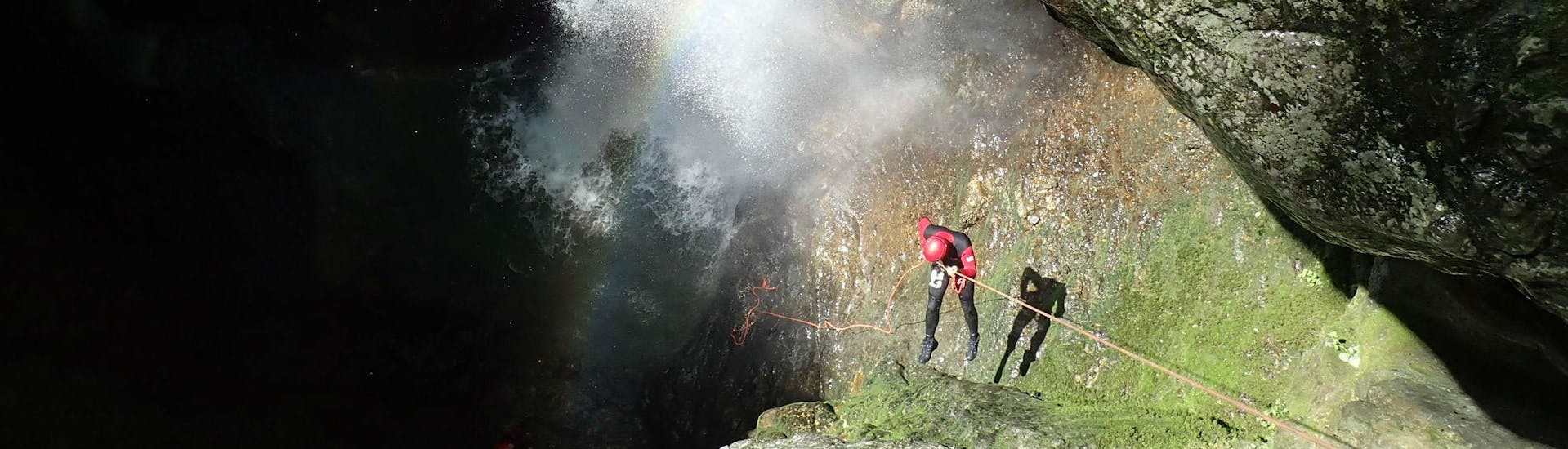 A canyoning enthusiast descends into a gorge by abseiling during a canyoning tour organised by Terréo Canyoning.