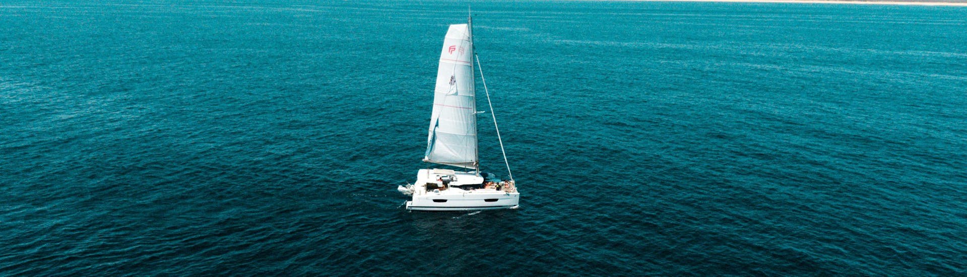 Photo of a Catamaran sailing in the Algarve with The Ocean Week Portugal.
