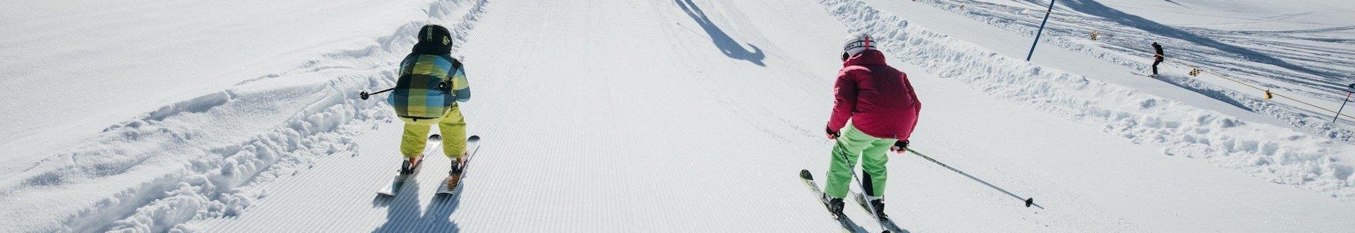 Adults and kids skiing in Turracher ski resort.