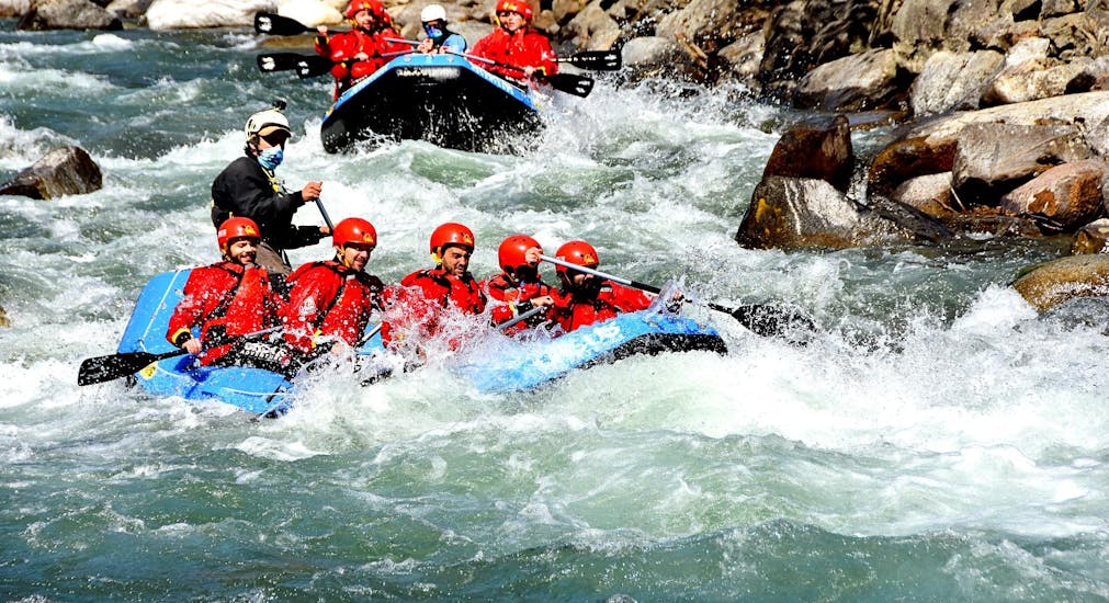 A group is rafting in Val di Sole with Ursus Adventures. 