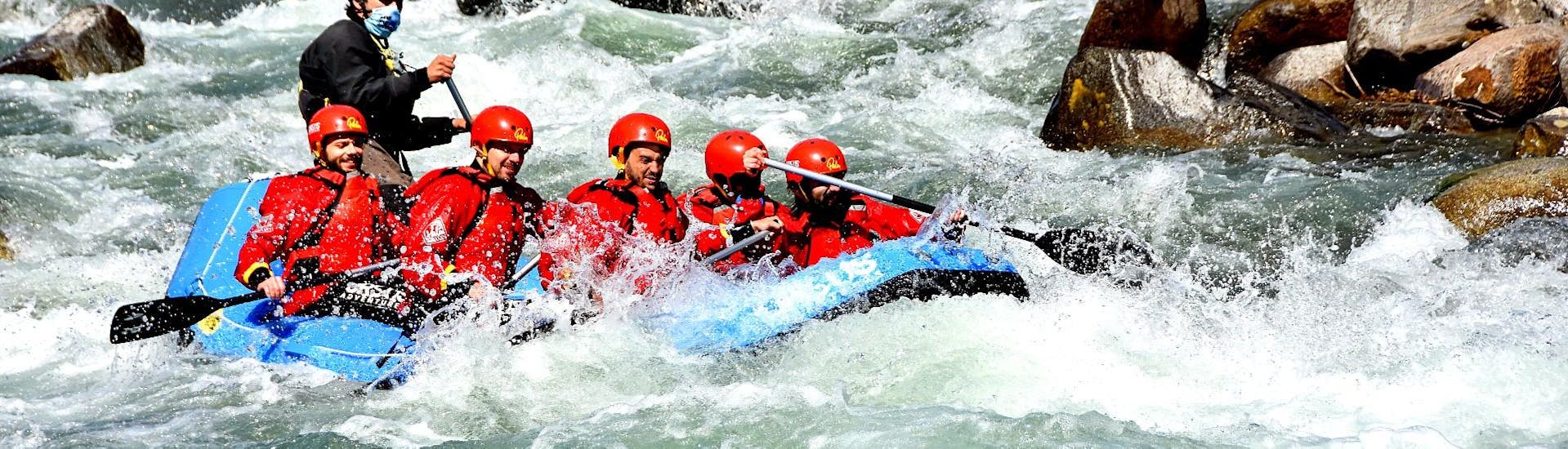 A group is rafting in Val di Sole with Ursus Adventures. 