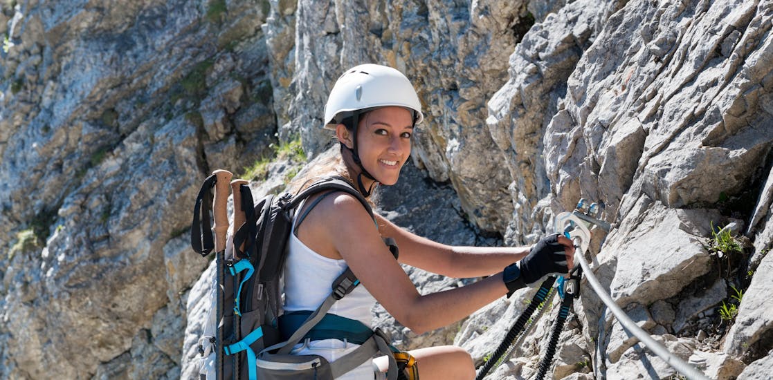Woman climbing on a Via Ferrata