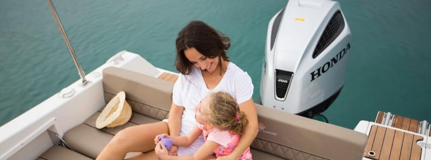 A woman and her daughter enjoying while sailing around Pula.