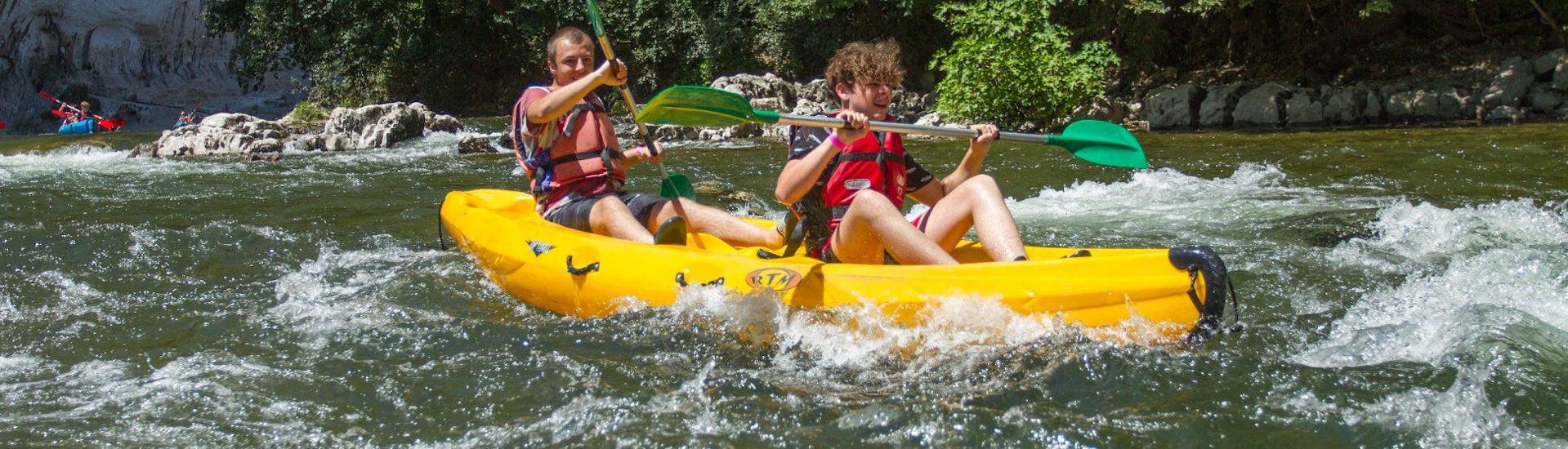 Deux garçon qui s'amusent en faisant du canoë sur l'Ardèche grâce à l'offre proposée par Viking Bateaux en France.