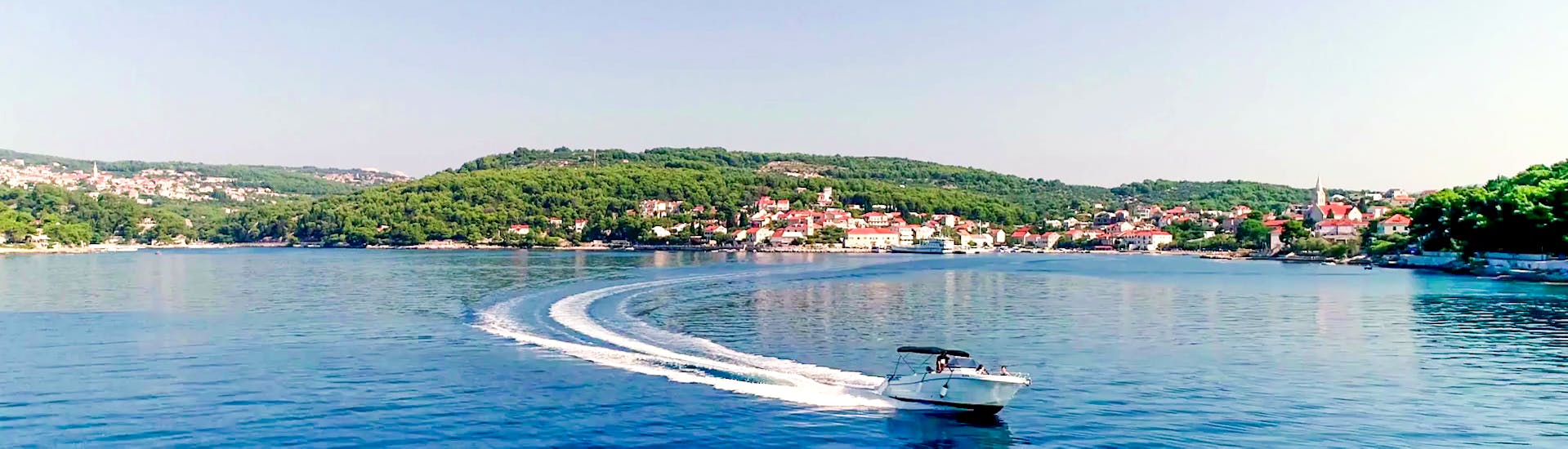 Lancha rápida en un hermoso mar con un bonito paisaje de Trogir de un viaje en barco con Waterworld Croacia.