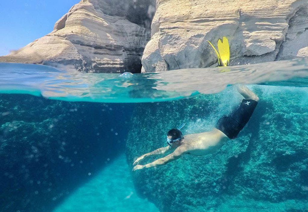Volcano Boat Adamantas Picture of a person doing some snorkeling in turquoise water during Volcano Boat Adamantas trip.