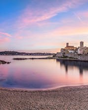 Panoramic view of the sunset from Plage de la Gravette, where many people come to do water sports in Antibes.