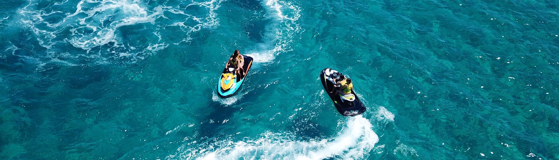 A group of friends riding a banana boat in the holiday destination of Perivolos.