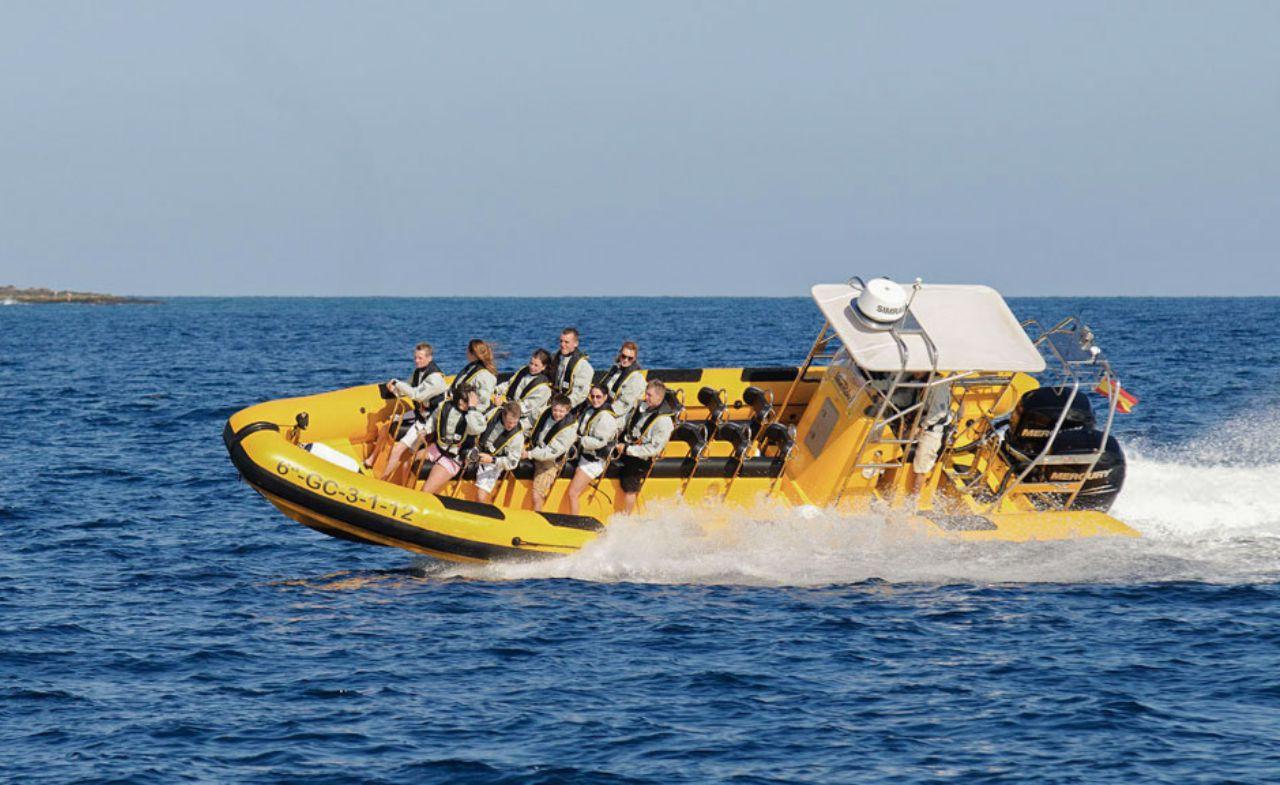 A speedboat in the sea with people having fun.