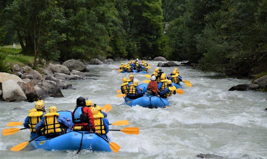 Some rafts are going down the river Noce during one of the rafting activities organized by X Raft Val di Sole.