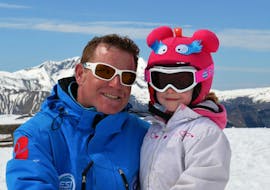 A European Ski School instructor and a young child have a great time on the slopes of Les Deux Alpes during private ski lessons for kids. 